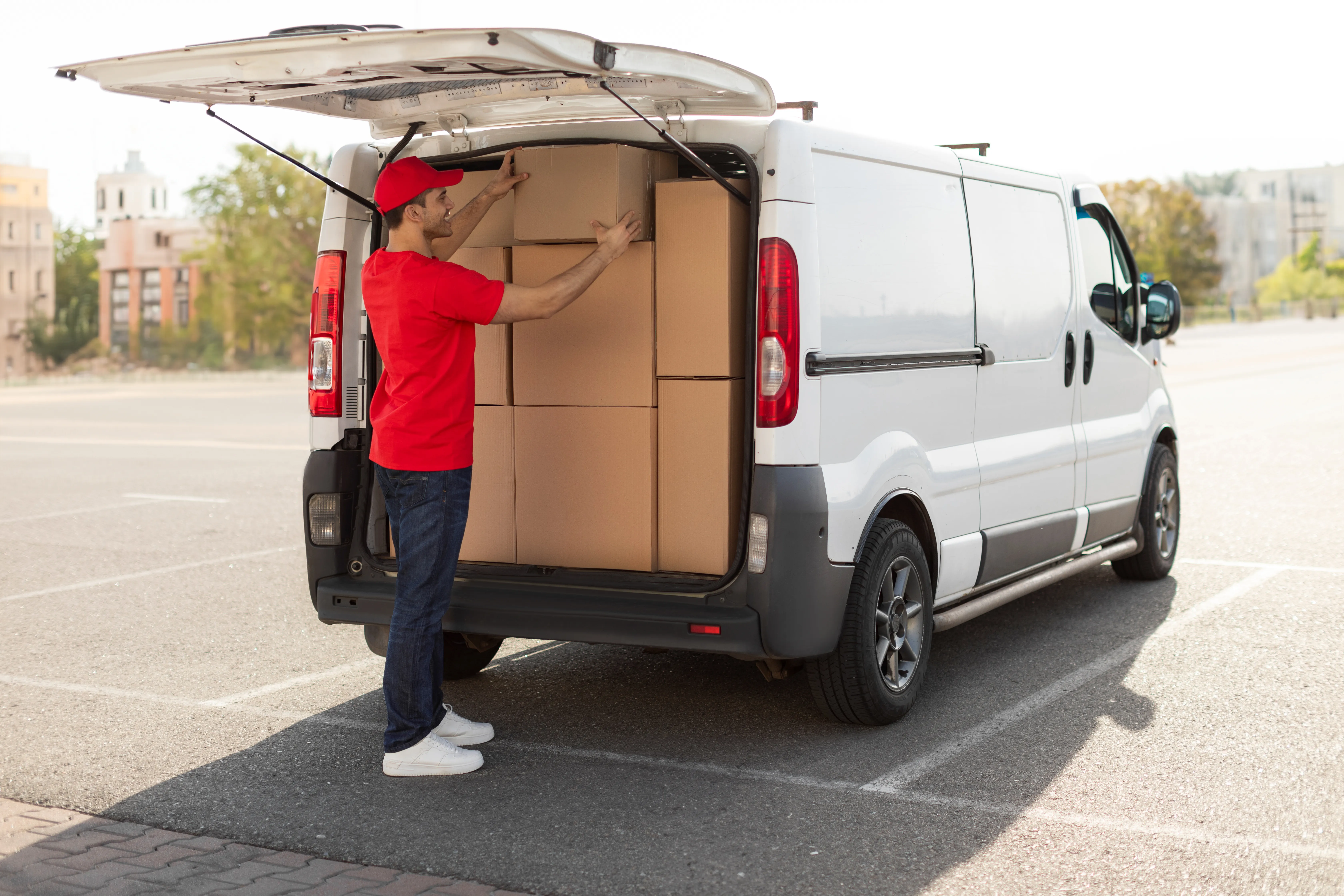 Courier loading boxes into short wheel base delivery van